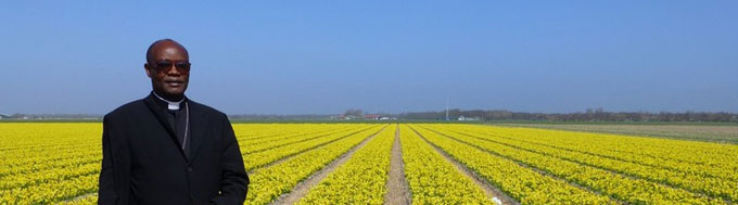 Mgr. Blaise voor de tulpenbedden